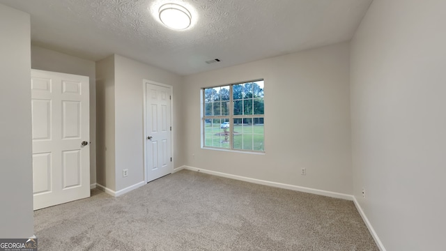 943 Colvin Dr, Locust Grove, GA 30248 - unfurnished bedroom featuring a textured ceiling, visible vents, baseboards, and carpet