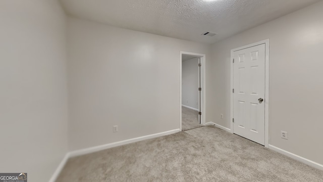 943 Colvin Dr, Locust Grove, GA 30248 - spare room with visible vents, carpet, baseboards, and a textured ceiling