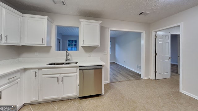 943 Colvin Dr, Locust Grove, GA 30248 - kitchen with a sink, white cabinets, stainless steel dishwasher, and visible vents