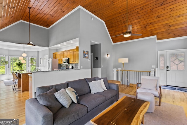 living area featuring crown molding, wooden ceiling, light wood-style floors, and high vaulted ceiling