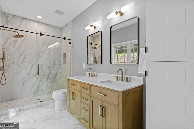bathroom with a sink, a marble finish shower, toilet, and double vanity