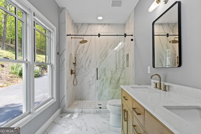 bathroom with a sink, a marble finish shower, toilet, and marble finish floor