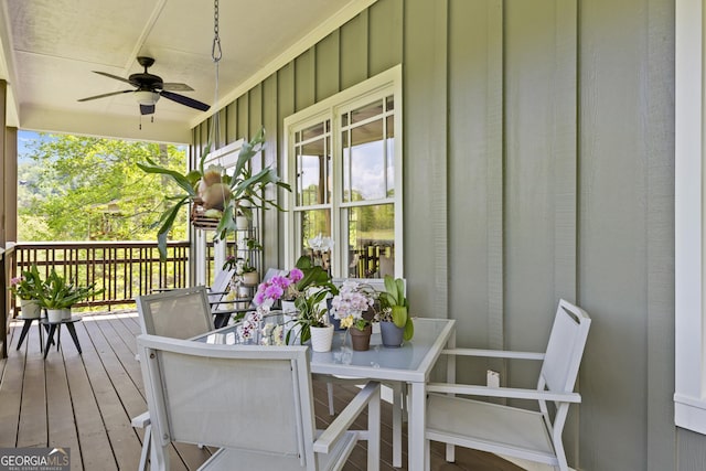 wooden deck with covered porch and a ceiling fan