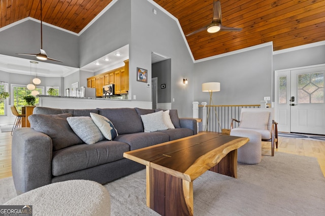 living room with wood ceiling, ceiling fan, crown molding, high vaulted ceiling, and light wood-style flooring