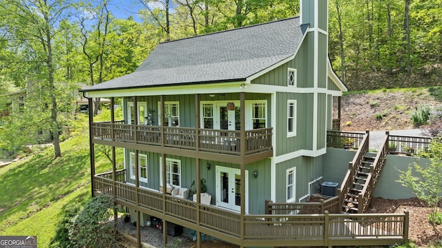 exterior space featuring board and batten siding, french doors, a shingled roof, and a wooden deck