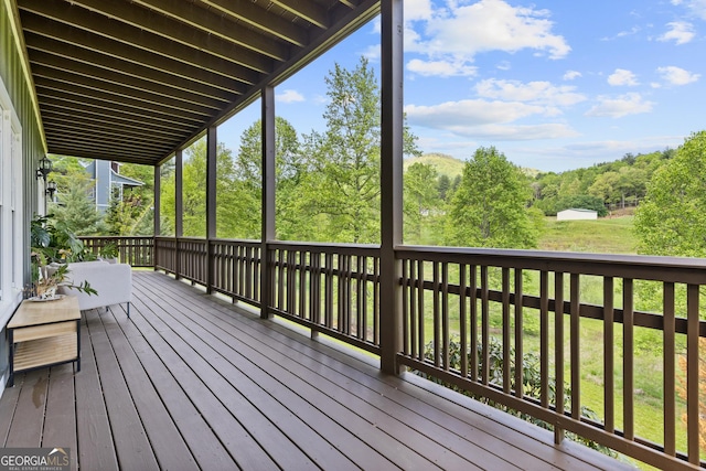 wooden deck featuring a yard