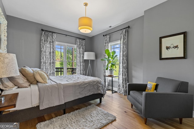 bedroom featuring access to outside and hardwood / wood-style floors