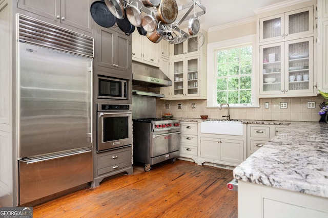 1464 Twin Pines Dr, Macon, GA 31211 - kitchen with a sink, built in appliances, hardwood / wood-style floors, under cabinet range hood, and ornamental molding