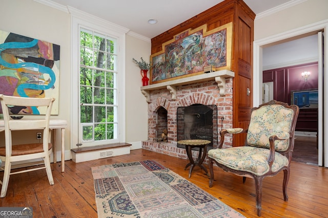 1464 Twin Pines Dr, Macon, GA 31211 - sitting room with visible vents, a brick fireplace, crown molding, and hardwood / wood-style flooring