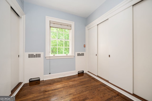 1464 Twin Pines Dr, Macon, GA 31211 - unfurnished bedroom featuring radiator and dark wood-style floors