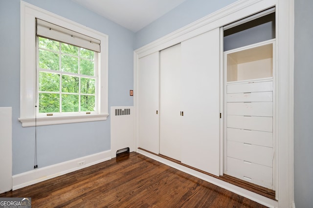 1464 Twin Pines Dr, Macon, GA 31211 - unfurnished bedroom with baseboards, dark wood-style floors, multiple windows, and a closet