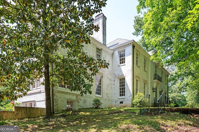 1464 Twin Pines Dr, Macon, GA 31211 - view of home's exterior featuring fence and a chimney