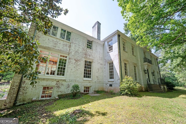 1464 Twin Pines Dr, Macon, GA 31211 - back of house with a lawn, brick siding, and a chimney