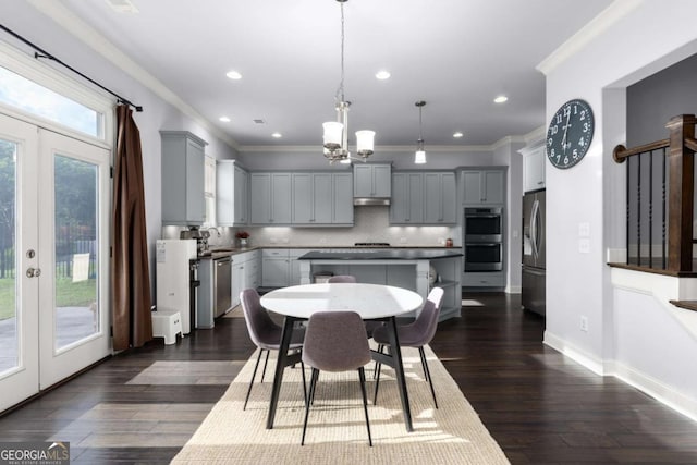 dining room featuring crown molding, a chandelier, dark wood-style floors, and french doors