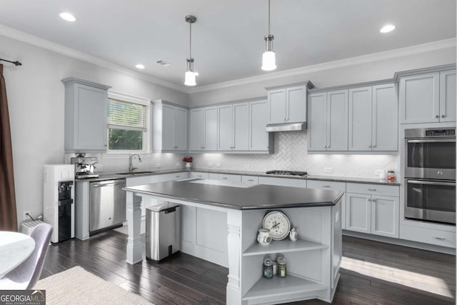 kitchen featuring open shelves, a sink, a center island, stainless steel appliances, and ornamental molding