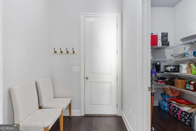 interior space featuring baseboards and wood finished floors