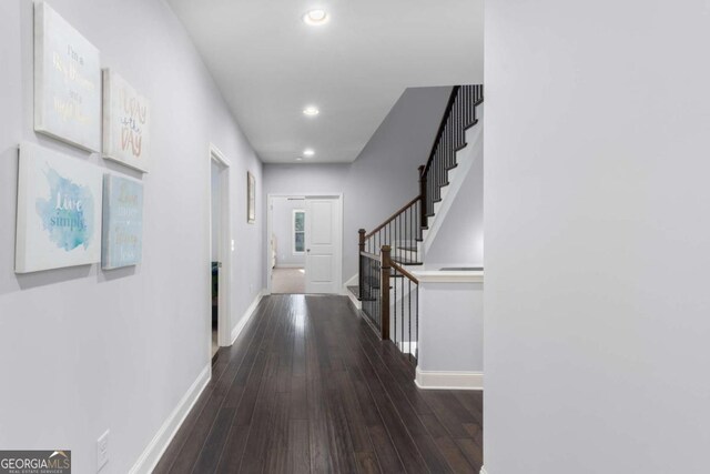 corridor with stairs, recessed lighting, baseboards, and dark wood-style floors
