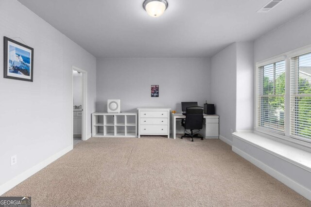 office with carpet floors, baseboards, and visible vents