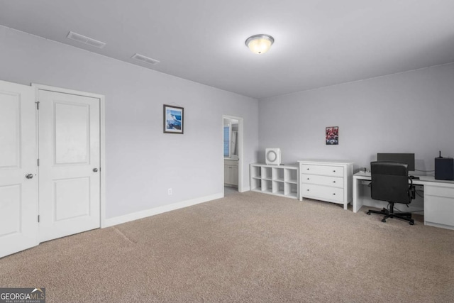 carpeted home office featuring visible vents and baseboards