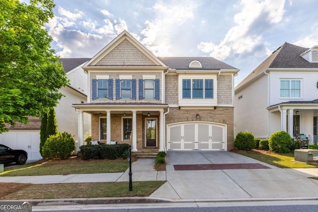 craftsman inspired home with a garage, a porch, and driveway