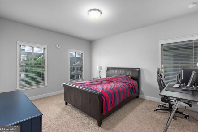 bedroom with carpet floors and baseboards