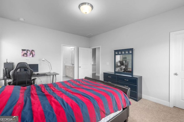 bedroom featuring carpet floors, baseboards, and ensuite bath