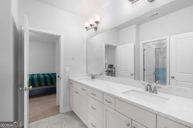 ensuite bathroom with visible vents, a sink, curtained shower, and double vanity