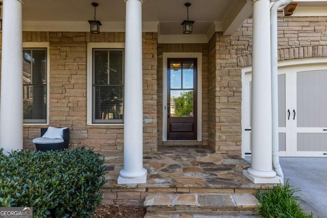entrance to property featuring covered porch and stone siding