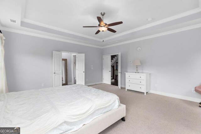 bedroom featuring baseboards, a raised ceiling, carpet floors, and visible vents