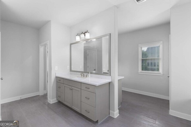 bathroom featuring vanity and baseboards