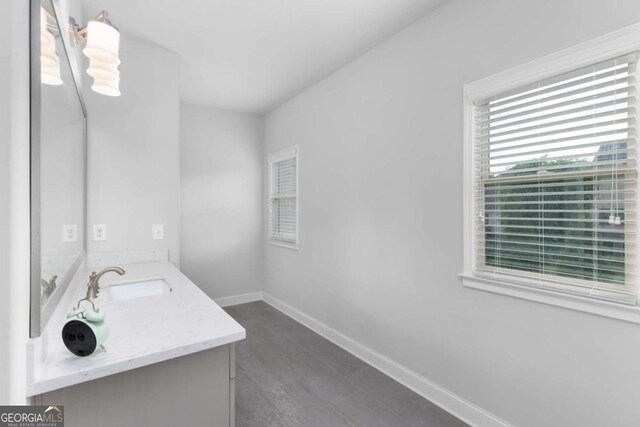 bathroom featuring baseboards and vanity
