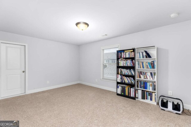 misc room with carpet floors, baseboards, and visible vents