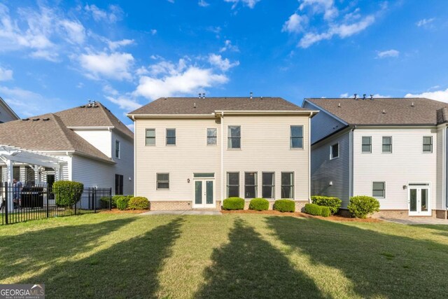 back of house with a yard, a pergola, fence, and french doors