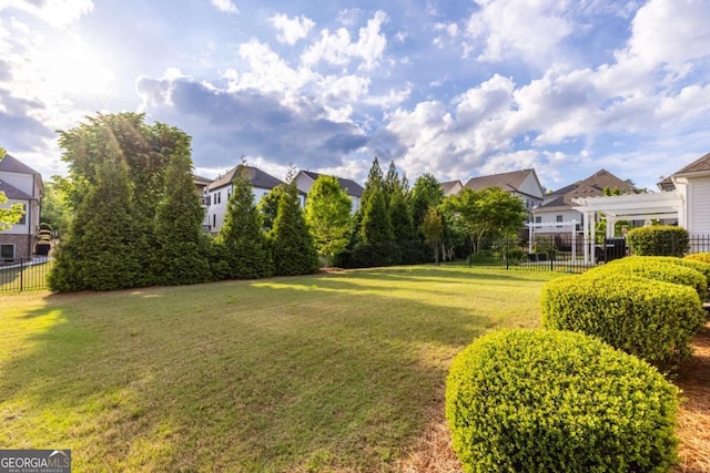 view of yard featuring fence and a residential view