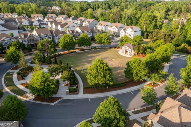 birds eye view of property with a view of trees and a residential view