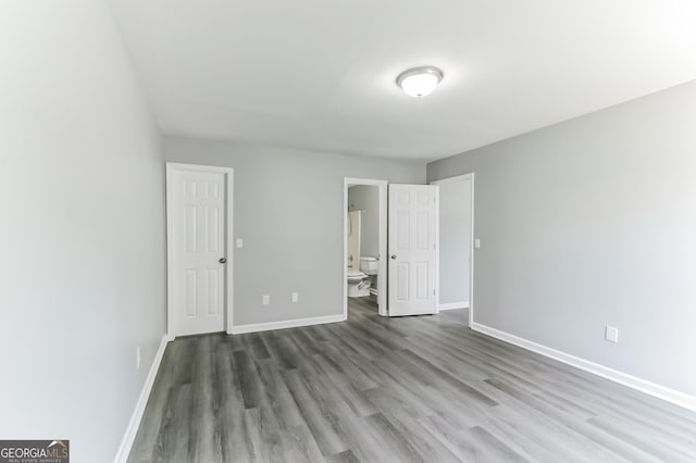 5452 Sweetsprings Dr SW, Powder Springs, GA 30127 - unfurnished bedroom with baseboards, wood finished floors, and ensuite bath