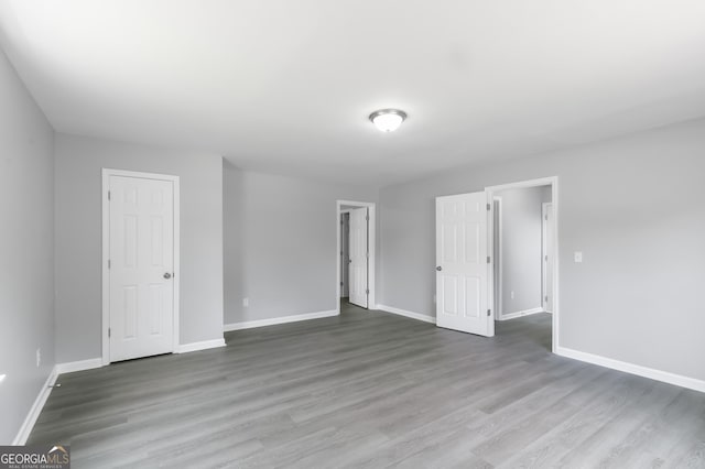 5452 Sweetsprings Dr SW, Powder Springs, GA 30127 - unfurnished bedroom featuring baseboards and wood finished floors
