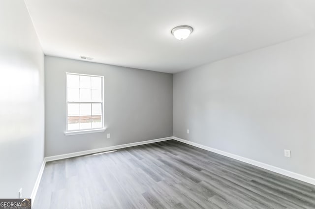 5452 Sweetsprings Dr SW, Powder Springs, GA 30127 - spare room with baseboards, visible vents, and wood finished floors
