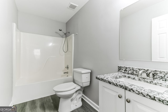 5452 Sweetsprings Dr SW, Powder Springs, GA 30127 - full bath featuring visible vents, wood finished floors, vanity, toilet, and  shower combination