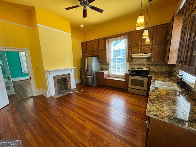 589 Meigs St, Athens, GA 30601 - kitchen with ceiling fan, a fireplace with flush hearth, appliances with stainless steel finishes, a sink, and under cabinet range hood