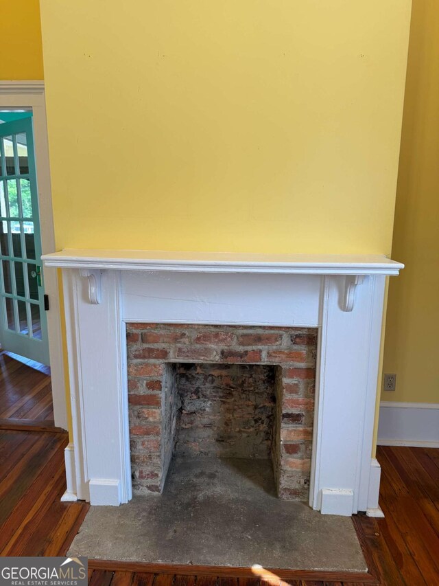 589 Meigs St, Athens, GA 30601 - room details with a brick fireplace, baseboards, and wood finished floors