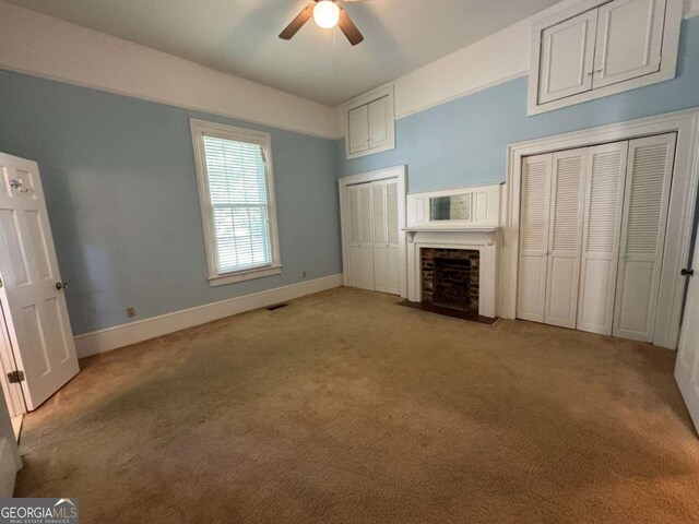 589 Meigs St, Athens, GA 30601 - unfurnished bedroom with a fireplace, multiple closets, baseboards, and light carpet