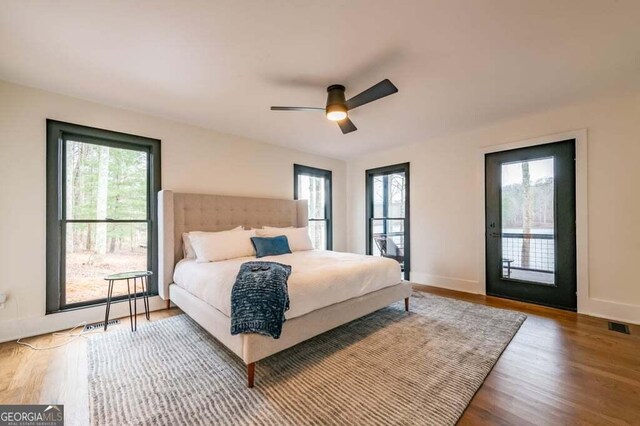 321 Fausetts Lake Rd, Dawsonville, GA 30534 - bedroom featuring access to exterior, a ceiling fan, baseboards, wood finished floors, and visible vents