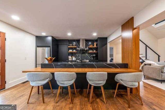 321 Fausetts Lake Rd, Dawsonville, GA 30534 - bar with light wood-type flooring, a sink, high end fridge, recessed lighting, and wall chimney exhaust hood