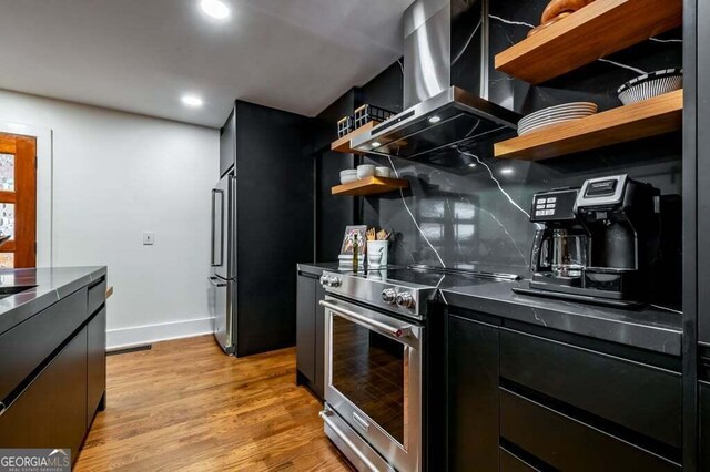 321 Fausetts Lake Rd, Dawsonville, GA 30534 - kitchen with open shelves, high end stainless steel range, dark cabinets, extractor fan, and light wood-style flooring