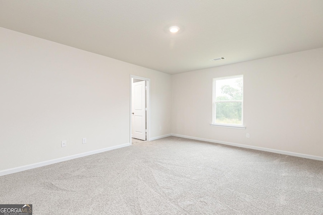 unfurnished room featuring baseboards, light carpet, recessed lighting, and visible vents