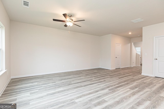 unfurnished room with ceiling fan, visible vents, light wood-type flooring, baseboards, and recessed lighting