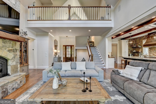 676 N Shore Dr, Cleveland, GA 30528 - living room featuring stairs, a towering ceiling, wood finished floors, baseboards, and recessed lighting