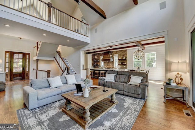 676 N Shore Dr, Cleveland, GA 30528 - living room featuring beam ceiling, wood finished floors, stairs, and high vaulted ceiling