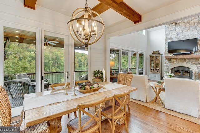sunroom with french doors, beamed ceiling, a chandelier, and a wealth of natural light